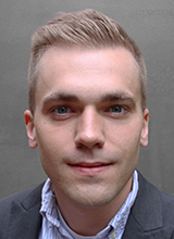 Man wearing a suit jacket over a collared shirt,