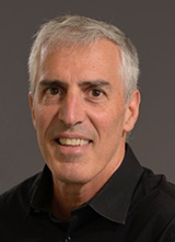 Man with short gray hair wearing a black shirt