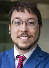 Man wearing a blue suit with a red striped tie